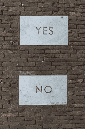 Brick wall with “Yes” and “No” signs